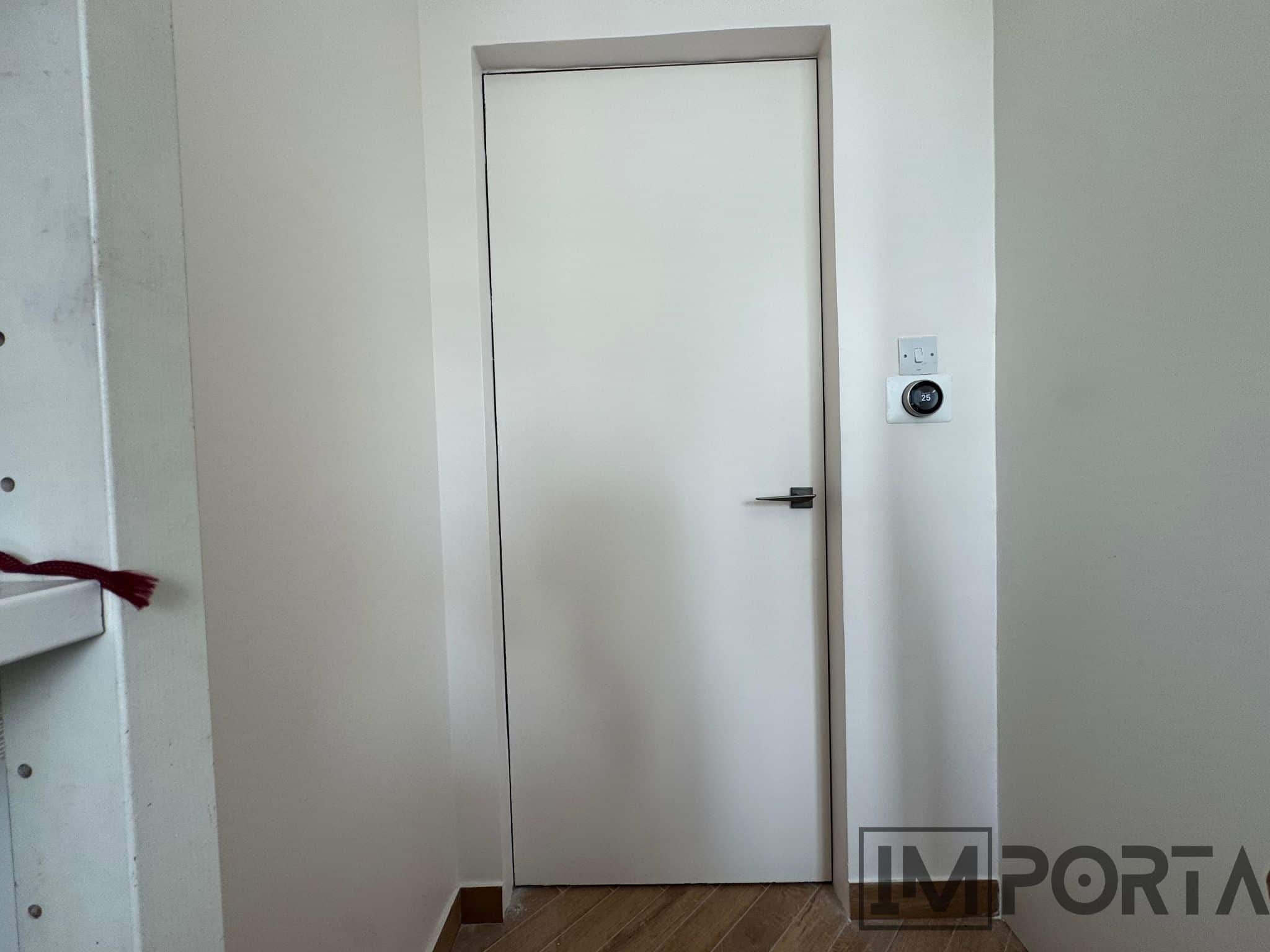 white-primed-hidden-door-gold-profile-importa.jpg