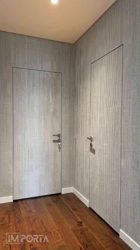 importa mormorino concretto concealed door calacatta marble finish