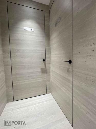 minimalist hidden door tile wall continuity design