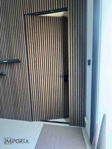 travertini linear slat wall concealed door system