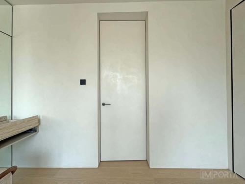 travertini minimalist white concealed door dubai interior