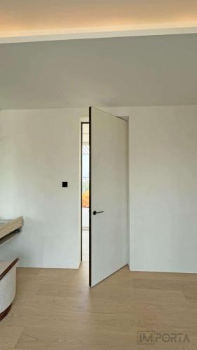 travertini modern concealed door gold frame interior