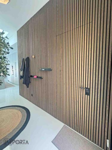 travertini wood slat wall hidden door design